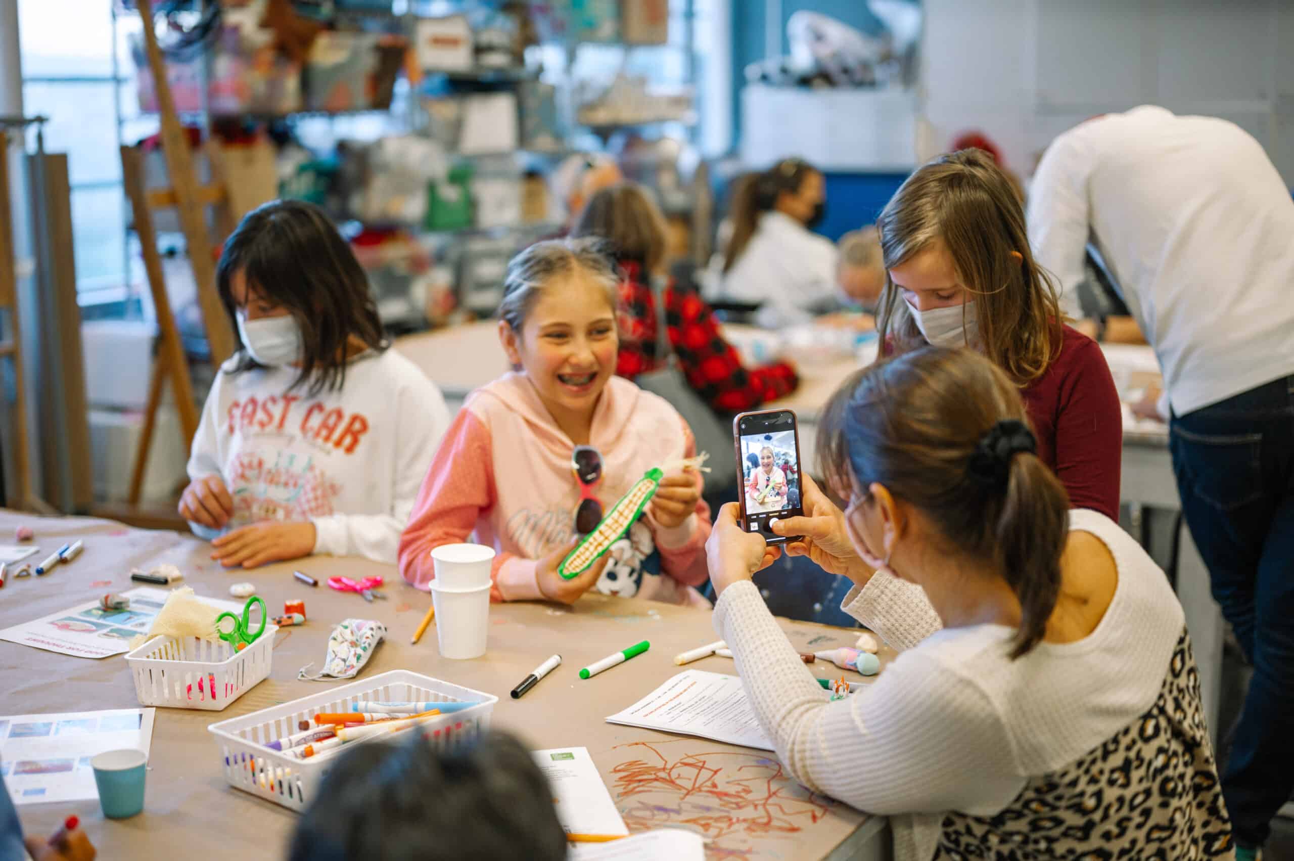Girls at table working on art projects