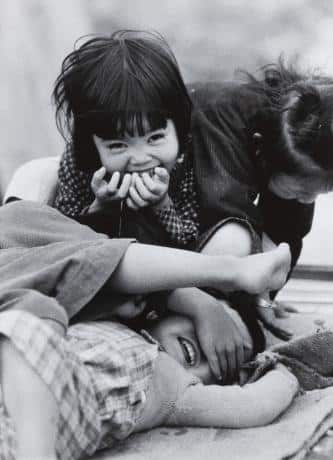 Black and white photograph of young children playing