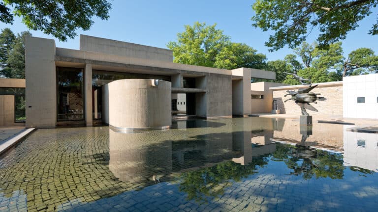 Photo of the courtyard reflecting pool in summer with I. M. Pei's building in the background
