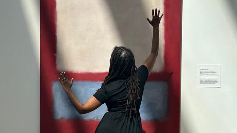 Artist Helina Metaferia dancing in front of the Mark Rothko painting, "Light over Gray"