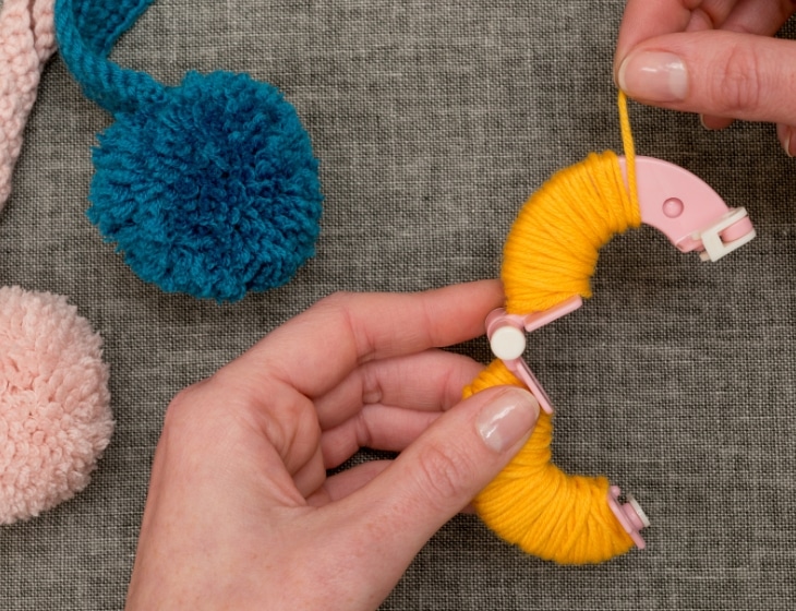 making pom-poms out of yarn