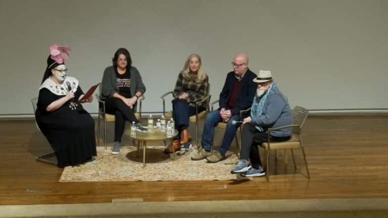 On stage, people sat for a panel discussion on Continuing Care featuring Becky Johnson, Marissa Mickunas, Gary Moore, and Michael Weeks, moderated by Sister Dia Niceas (Kara Raphaeli).